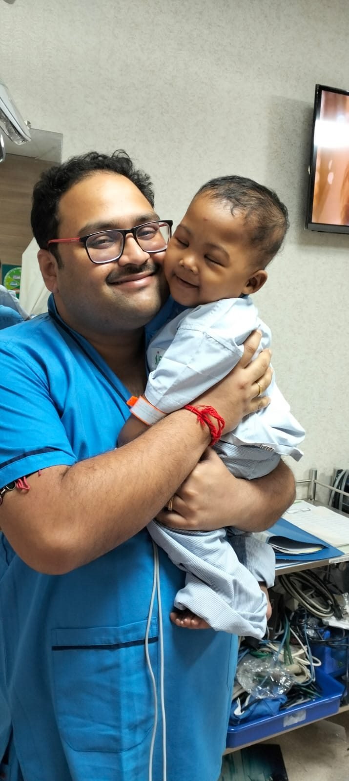 Dr. Saurodip Maity examining a young patient